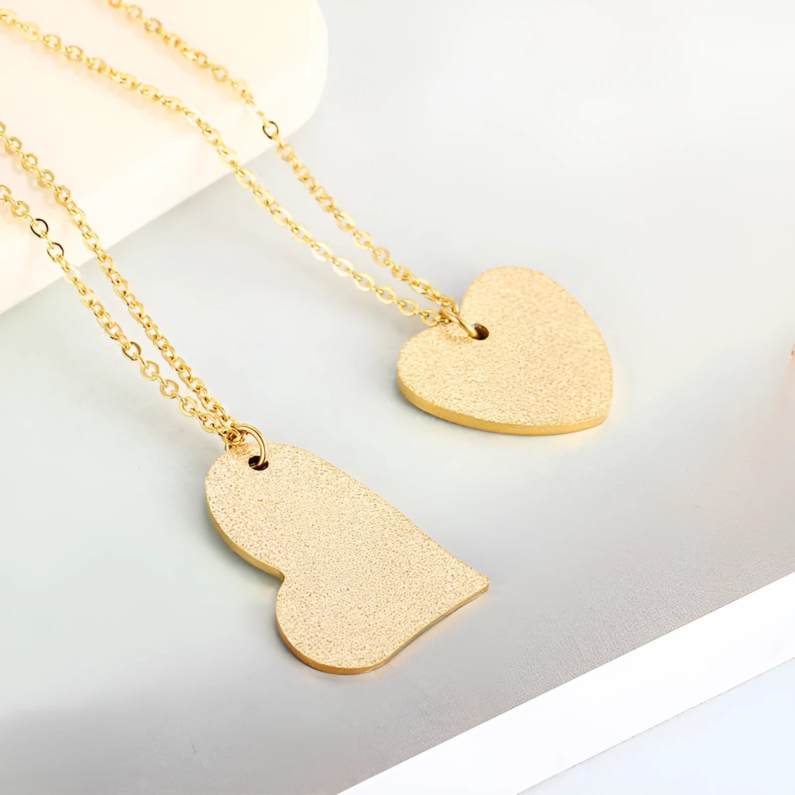 Geometric titanium steel pendant necklace with a heart-shaped neckline design in a metallic finish.