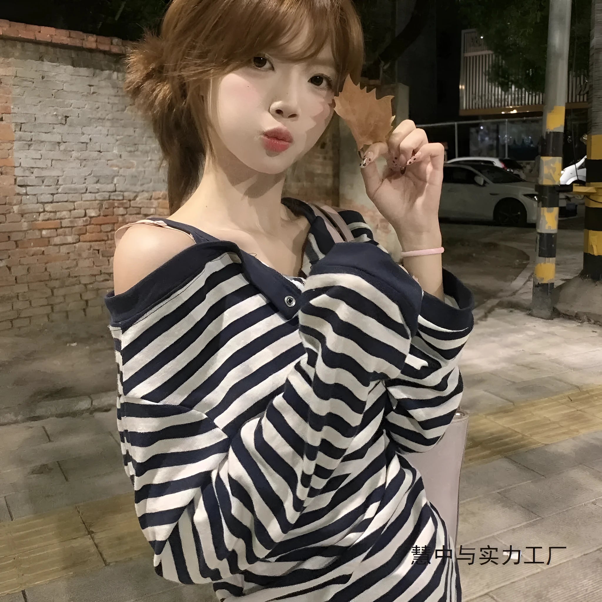 Dark blue women's oversized long sleeve t-shirt with stripes and embroidery detail.
