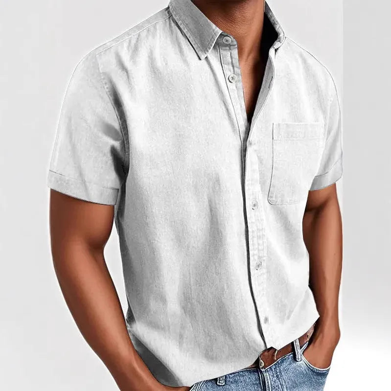 Man wearing a solid colour short-sleeved shirt with a polo collar and a single chest pocket.