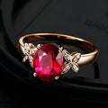 Women's butterfly and heart-shaped ring in copper with rose gold plating shown in red and blue colour options
