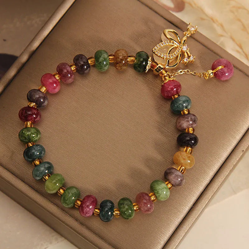 Colourful women's bracelet with a silver butterfly charm and multicoloured beads including tourmaline