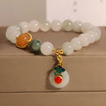Women's ice jade bracelet with xiangyun pattern, peace buckle, and pearl accents on a white background.