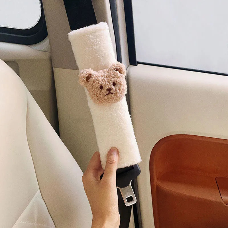 Cartoon bear plush seat belt shoulder cover for child car safety measuring 25cm by 6.5cm by 5cm.