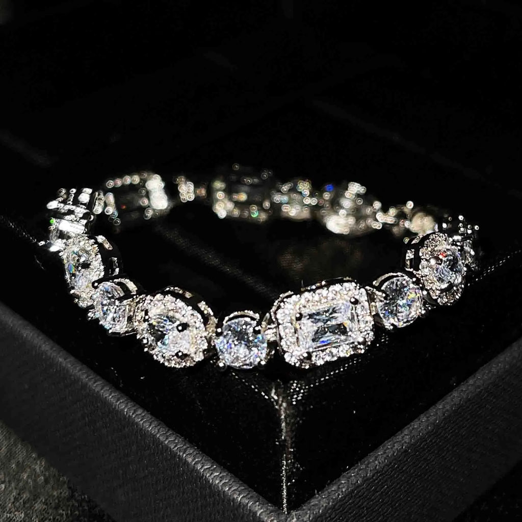 Women's geometric silver-plated bracelet with inlaid zircon stones on a wrist.