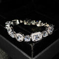 Women's geometric silver-plated bracelet with inlaid zircon stones on a wrist.