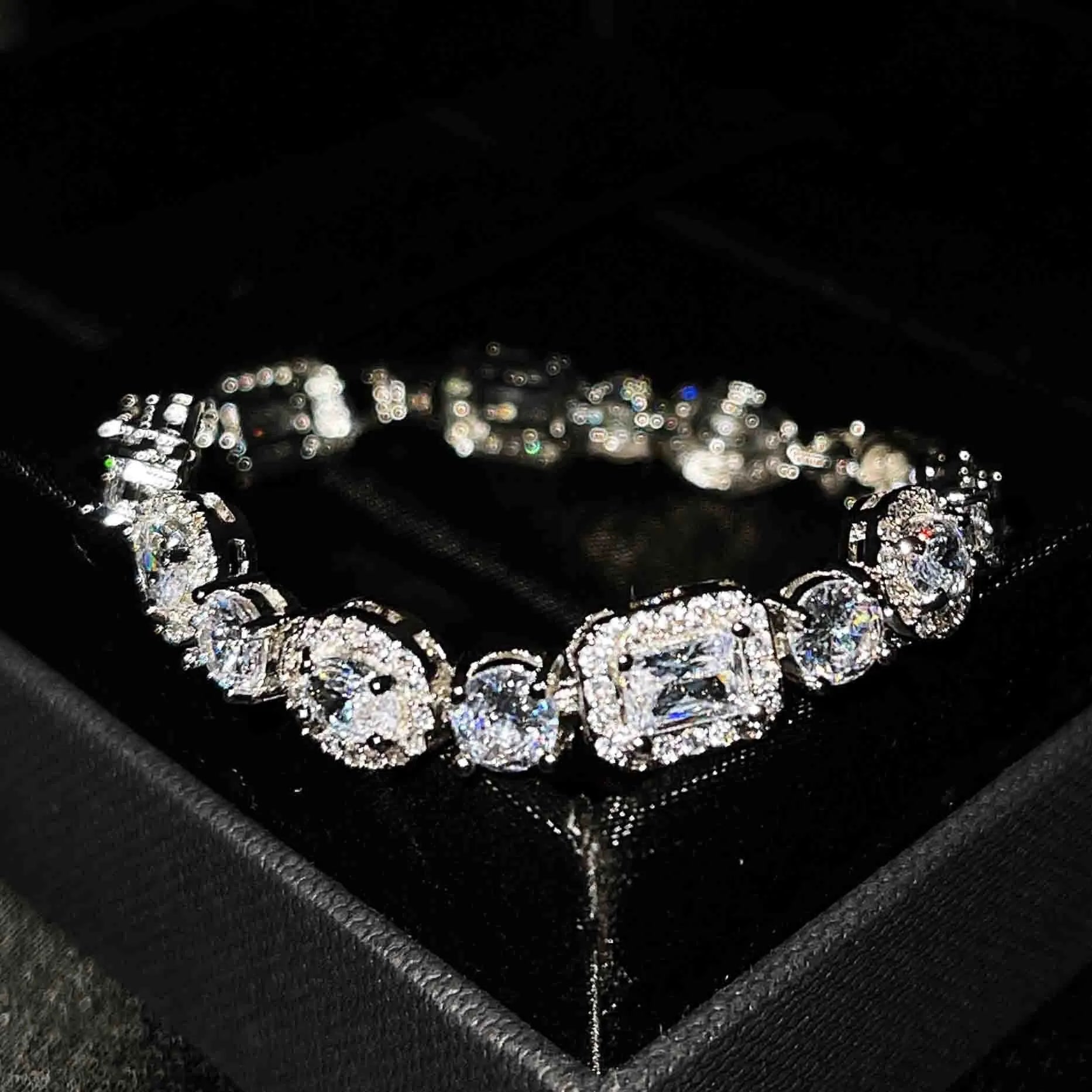 Women's geometric silver-plated bracelet with inlaid zircon stones on a wrist.