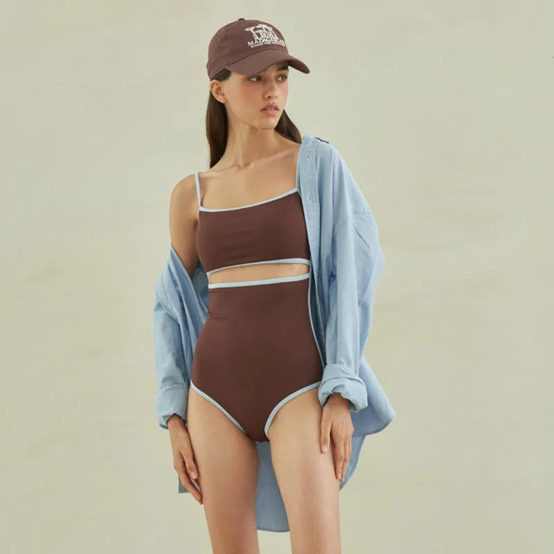 Brown women's one-piece triangle swimsuit showing front design on mannequin