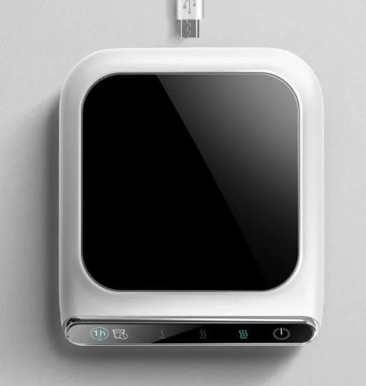 Black USB coffee mug warmer on a desk with a mug, showing three-speed control and tempered glass top.