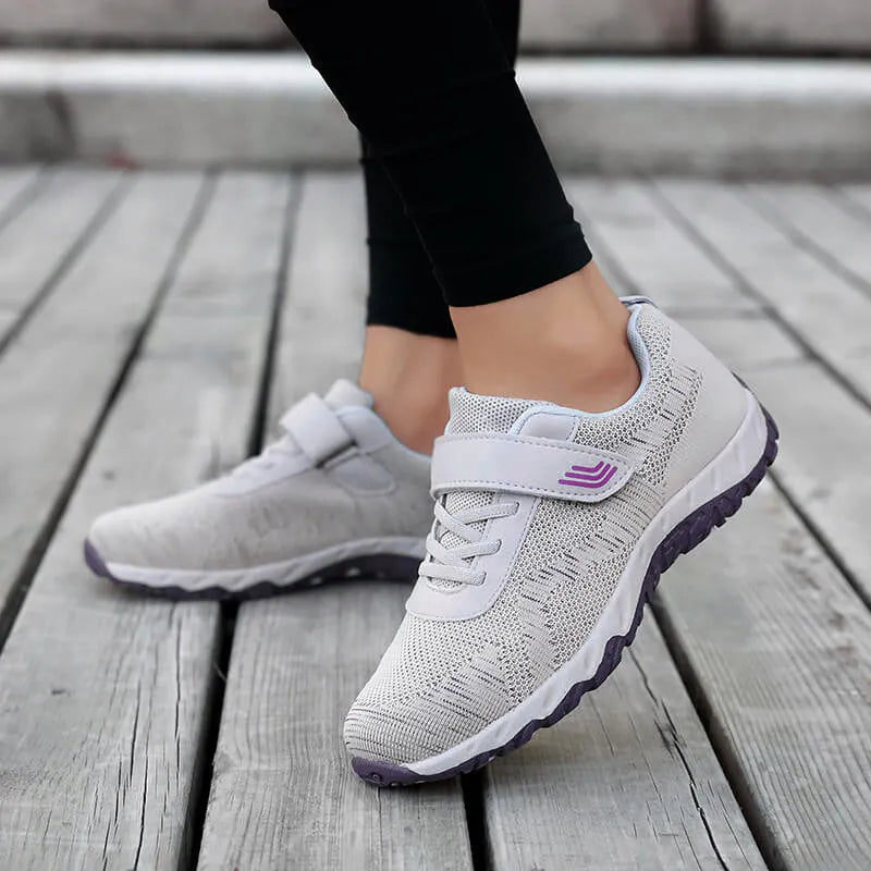 Women's low-top casual sneaker with mesh upper, wedge heel, and Velcro strap fastening.