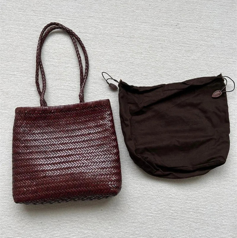 Brown handmade woven leather tote bag with a front pocket and polyester lining.