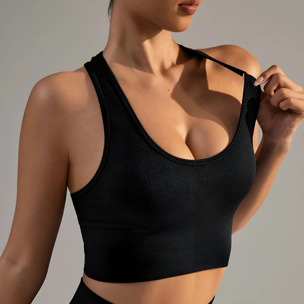 Black women's sports bra with cross-back design and moulded cups for running and yoga