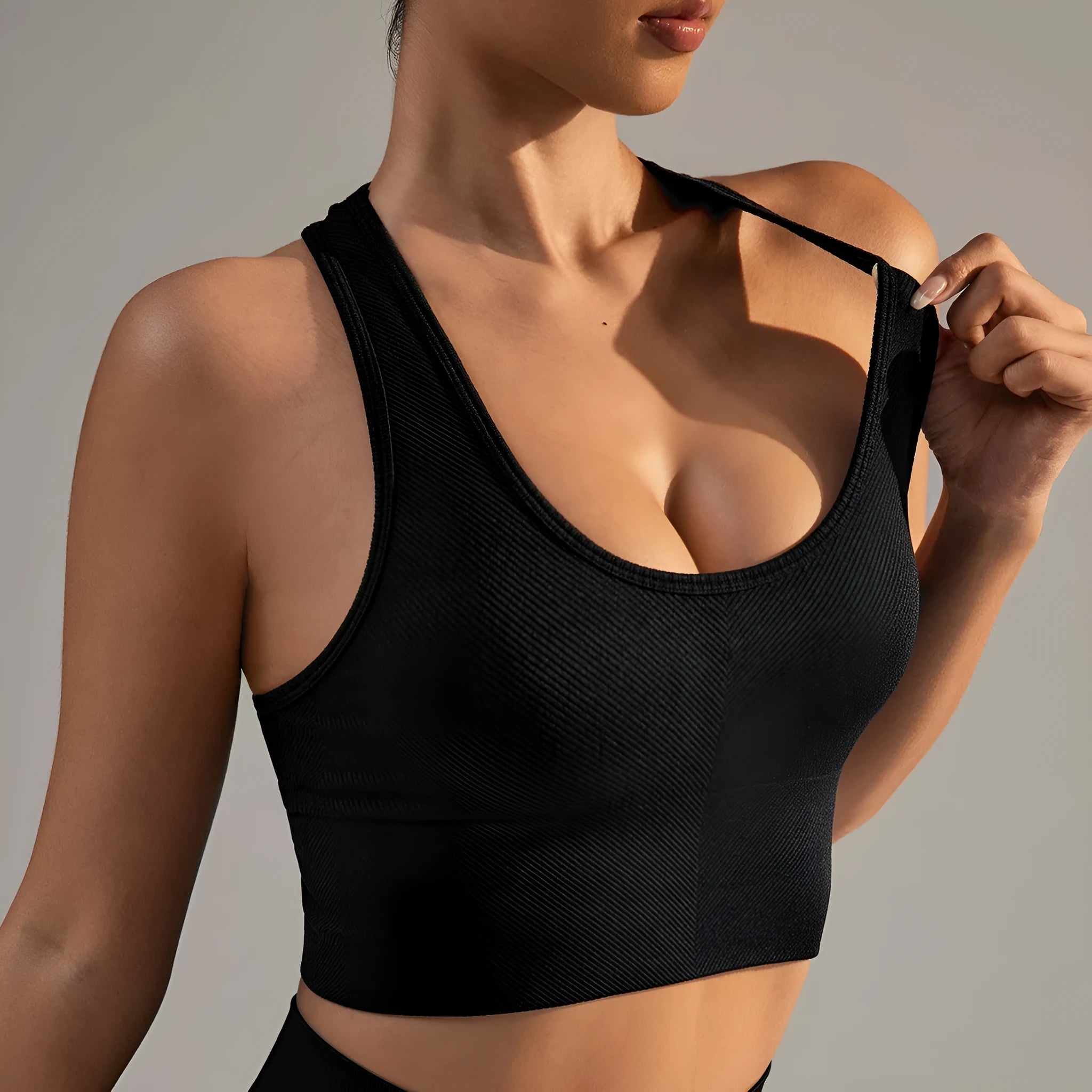 Black women's sports bra with cross-back design and moulded cups for running and yoga