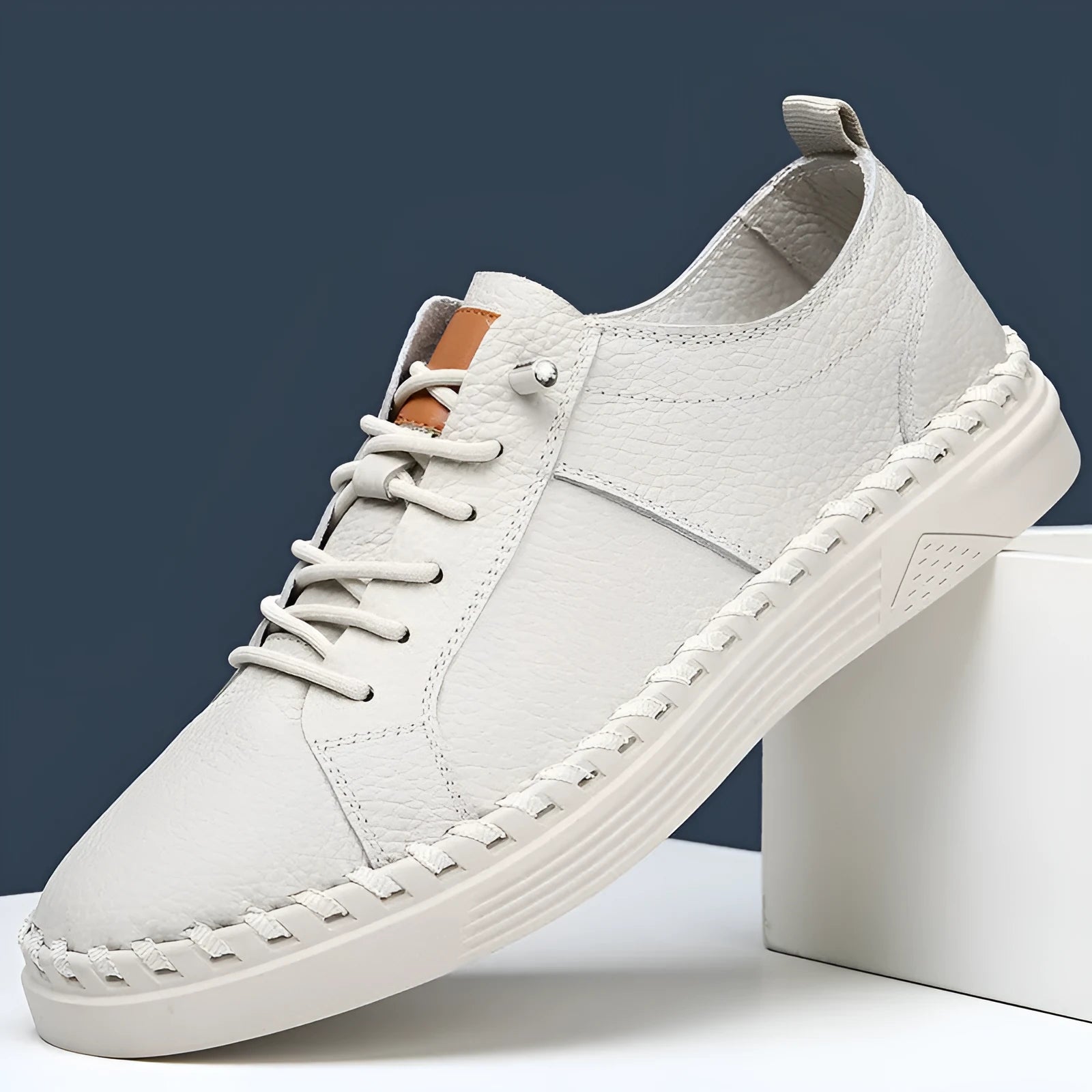 Men's beige cowhide leather casual sneakers with round toe and visible stitching.