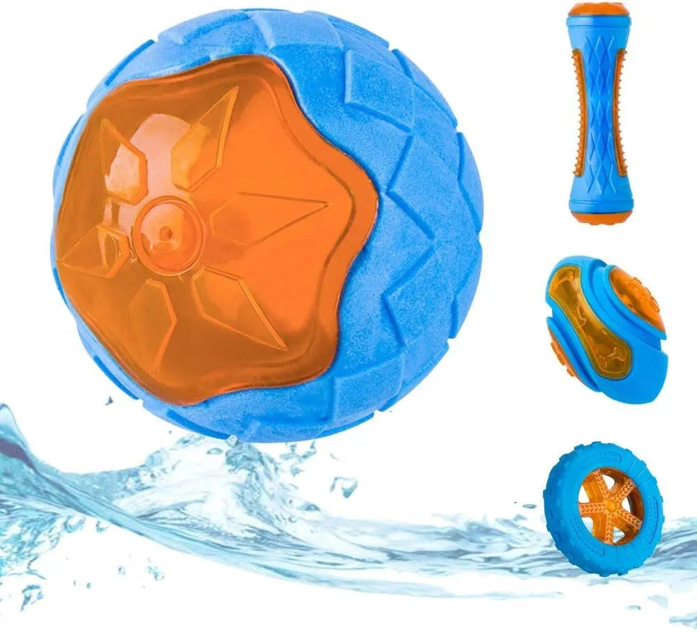 Three TPR floating dog toys: a red squeaky ball, a blue barbell, and an orange tyre, on a pool edge.