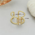 Gold-plated copper open ring with U-shape, adjustable opening, and asymmetrical design.