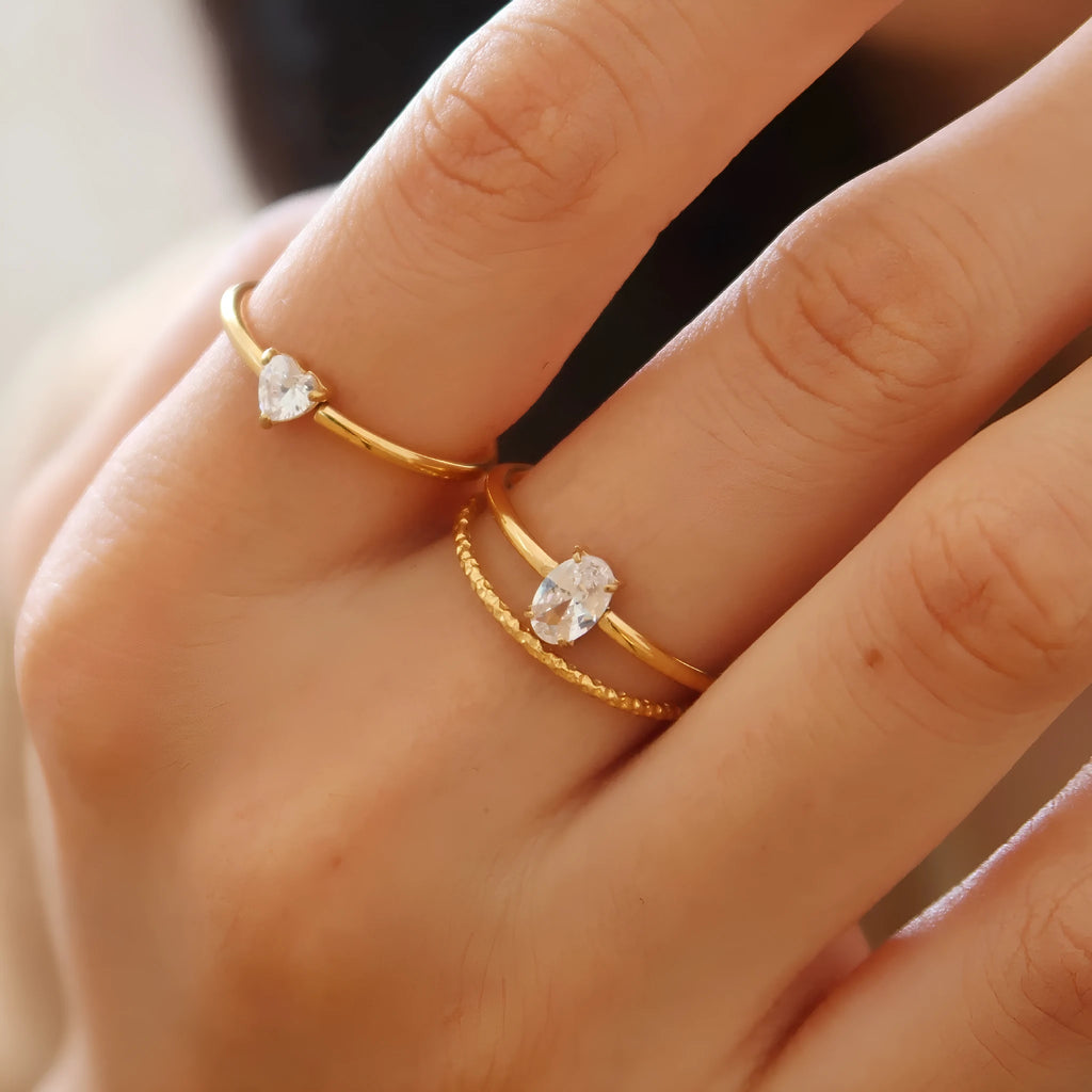 Golden love heart stainless steel ring for women on a simple band, shown in sizes no.5 to no.8