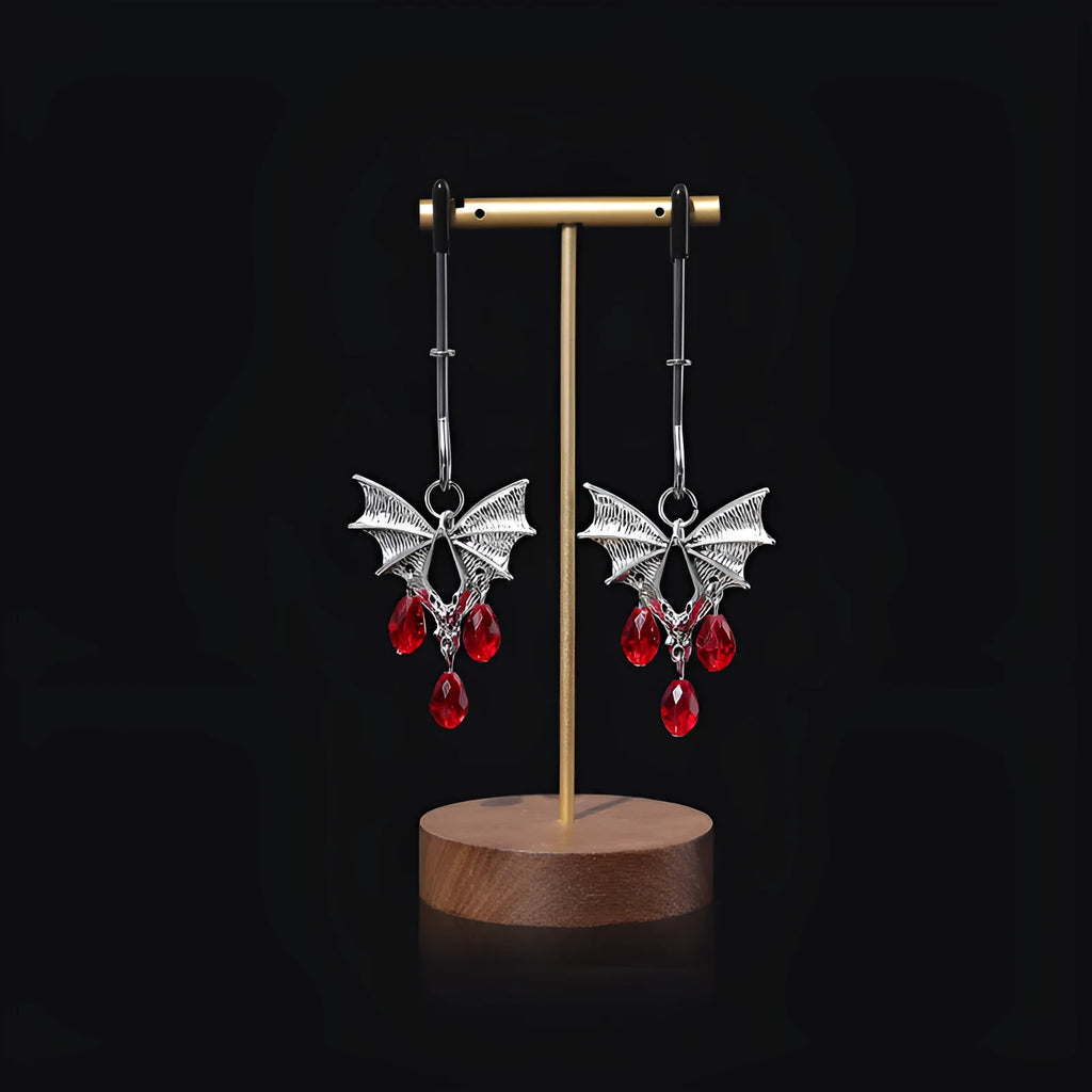 Silver bat nipple clamp with ruby detail and adjustable mechanism