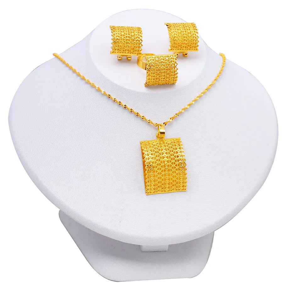 Gold coloured bridal jewellery set with necklace, earrings and ring on display