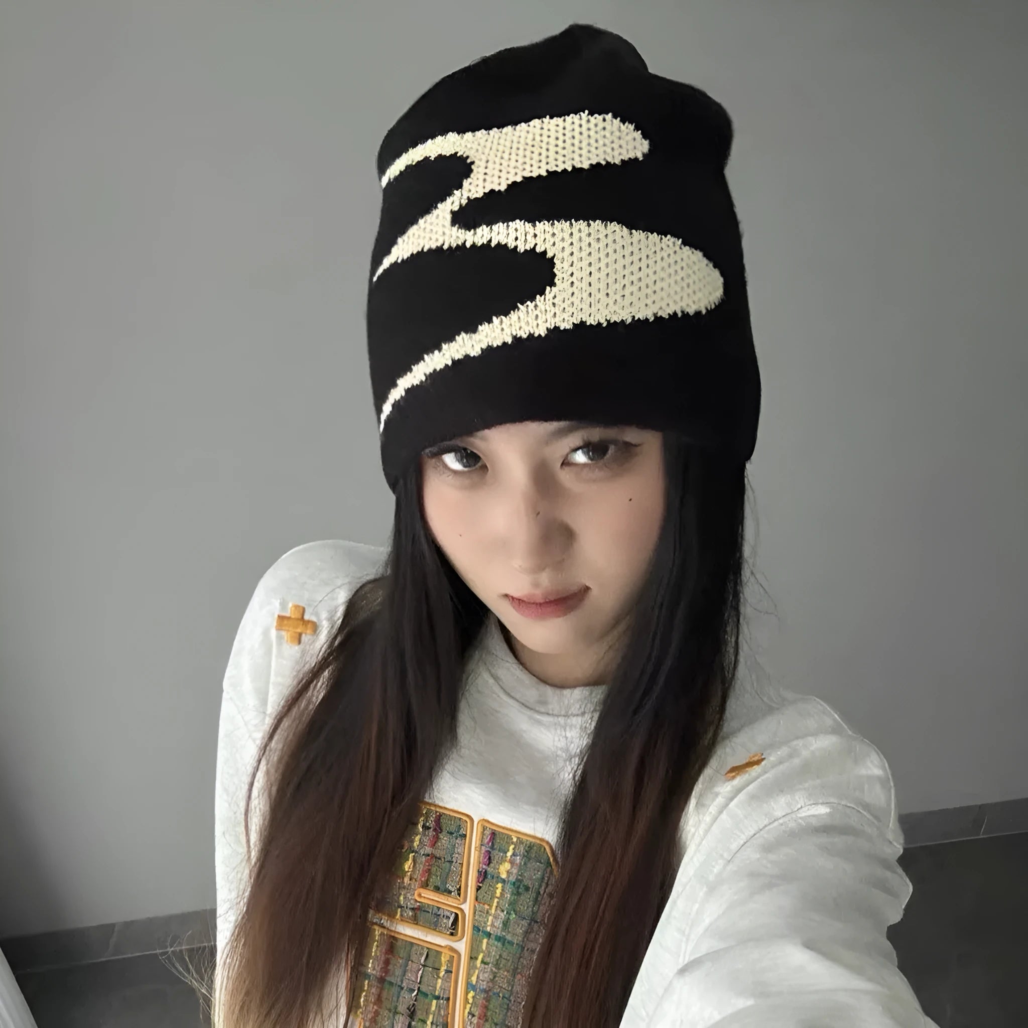Acrylic thermal knit beanie hat in black on a white background, showing ribbed texture.