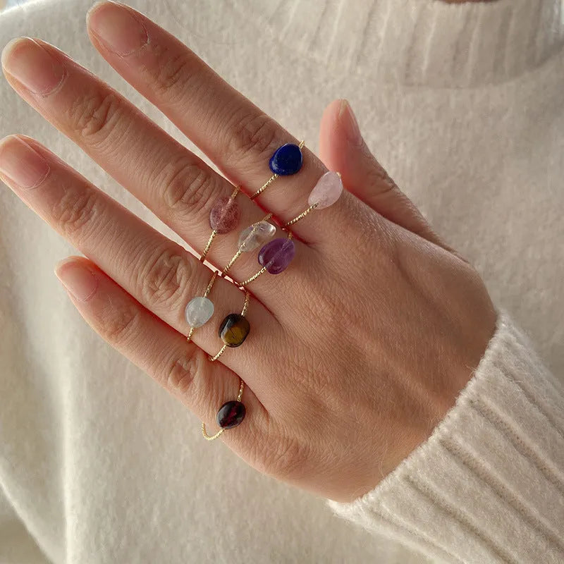 Close-up of a women's geometric agate ring showing its original design and coloured stone.