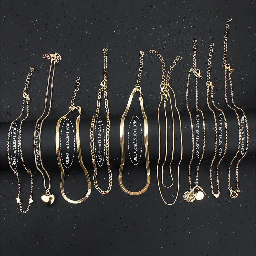 Ten gold electroplated necklaces with alloy pendants on adjustable snake bone chains