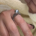 Adjustable geometric copper ring for women with a black pearl on an open band.