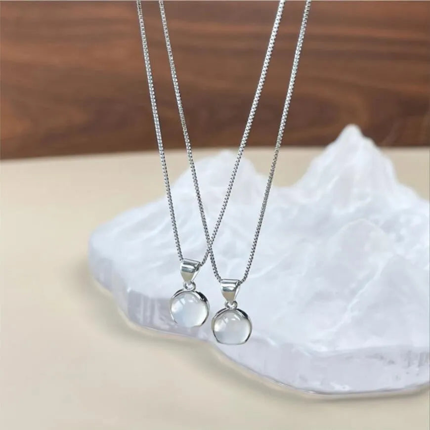 Women's oval artificial crystal pendant necklace with eight-point star detail on adjustable box chain