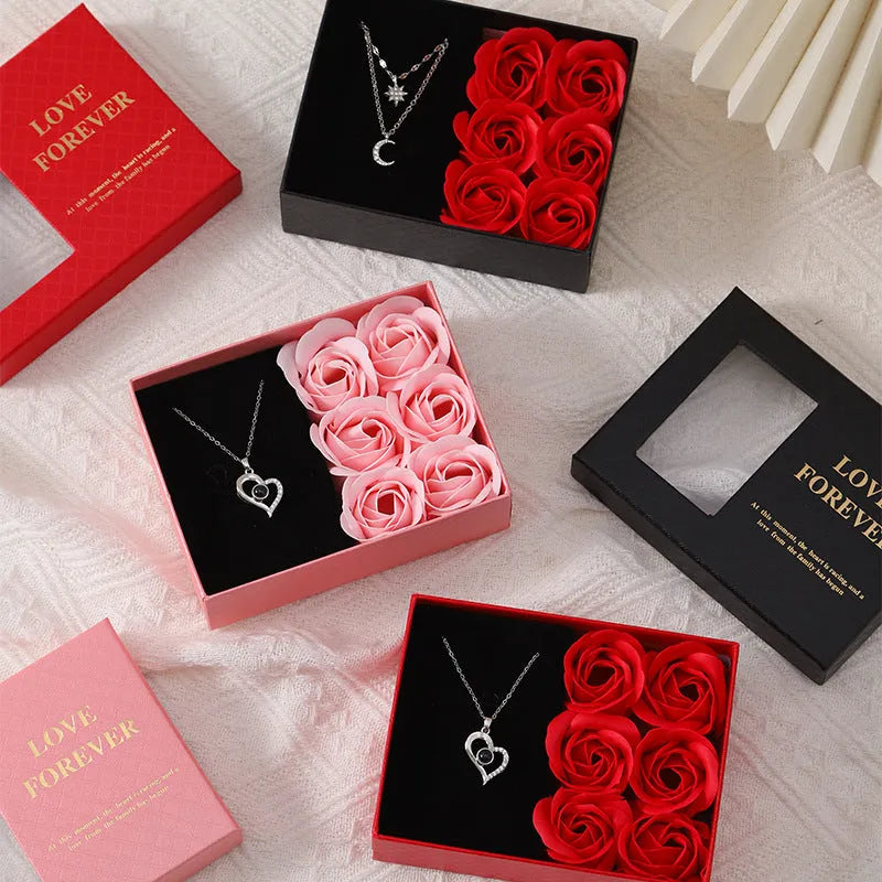 Six red soap flowers arranged in a black gift box with a matching handbag, a Valentine's Day gift set.