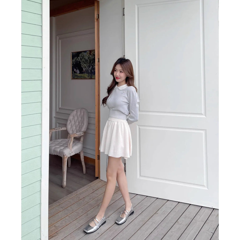 Women's silver leather Mary Jane flats with a cross buckle strap and round toe.