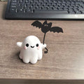 Mini resin statue of a ghost walking a dog and holding a bat, Halloween decoration.