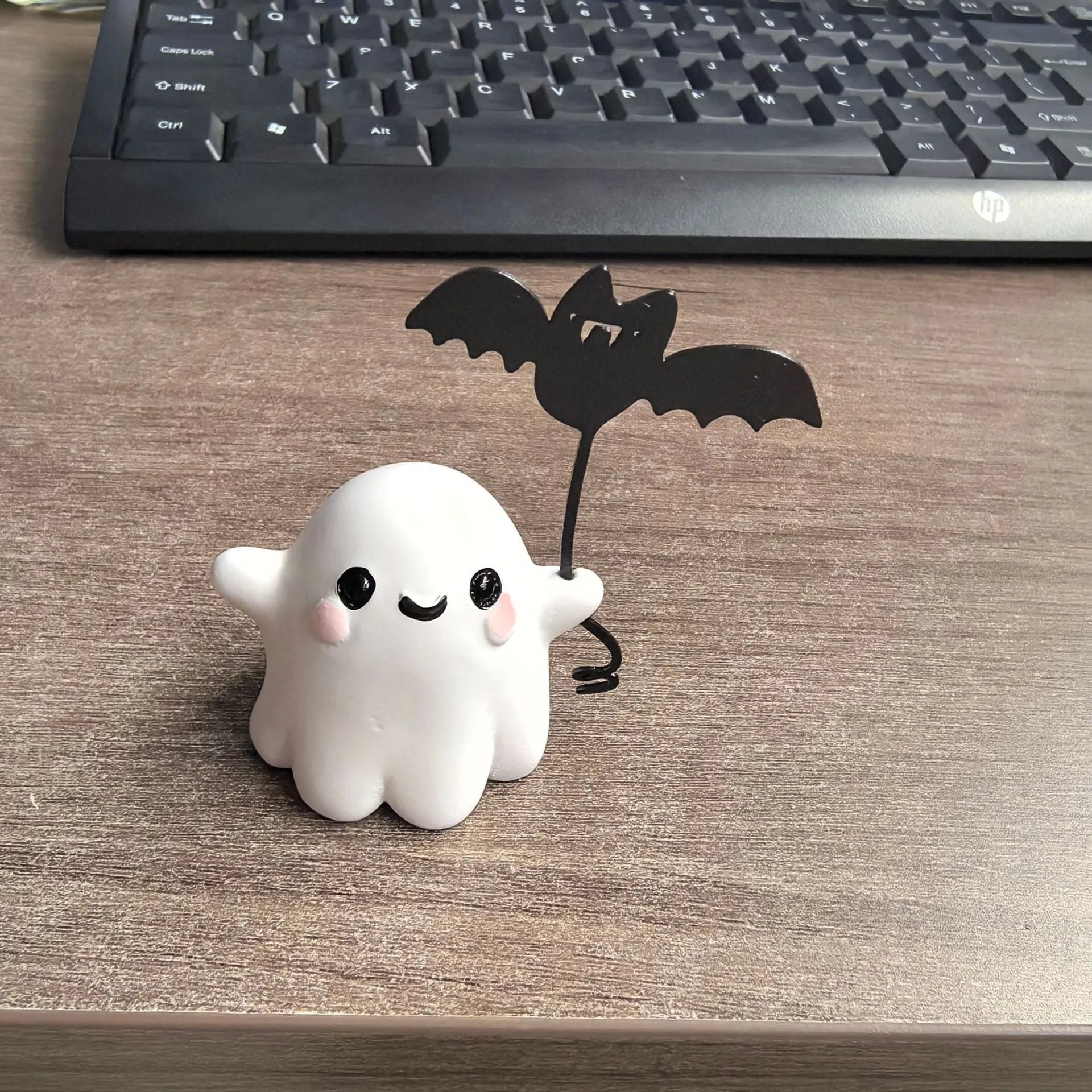 Mini resin statue of a ghost walking a dog and holding a bat, Halloween decoration.