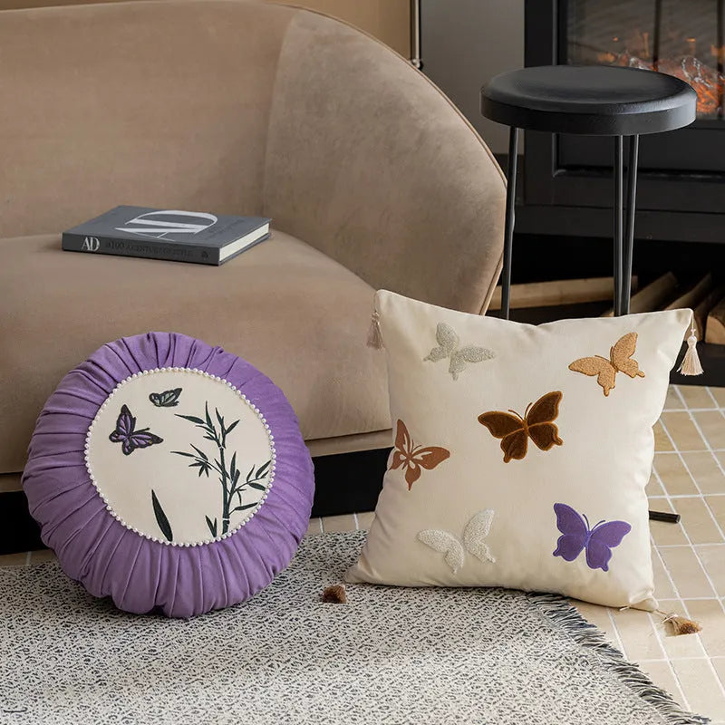 Square beige cushion with detailed Chinese style butterfly embroidery.