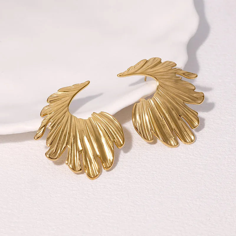A pair of stainless steel earrings in a leaves shape with a gold electroplated finish.