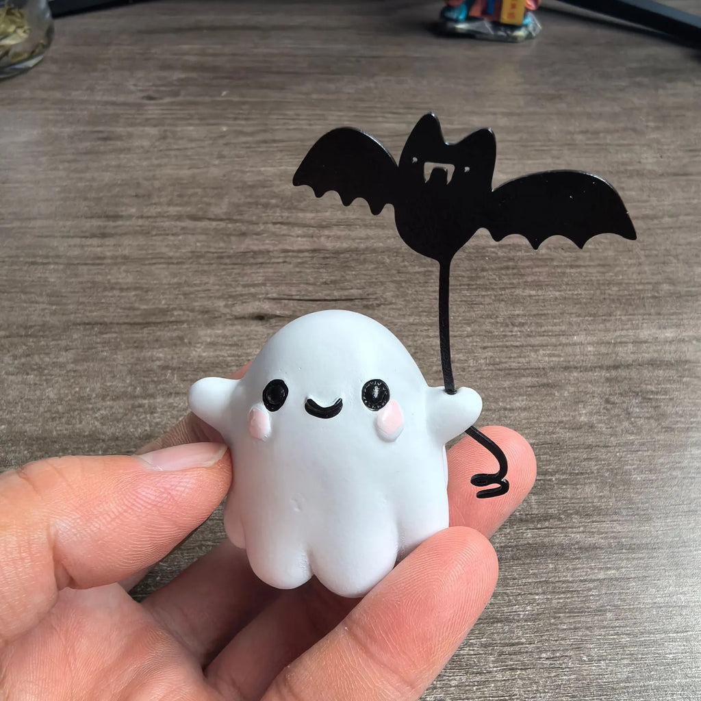 Mini resin statue of a ghost walking a dog and holding a bat, Halloween decoration.