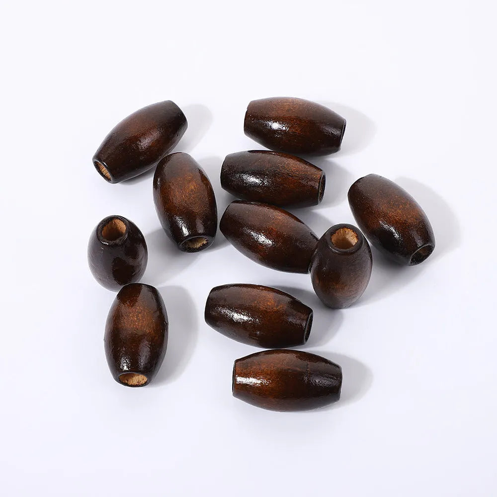 Oval M-shaped wooden bead in dark coffee colour with raised design, 25mm diameter
