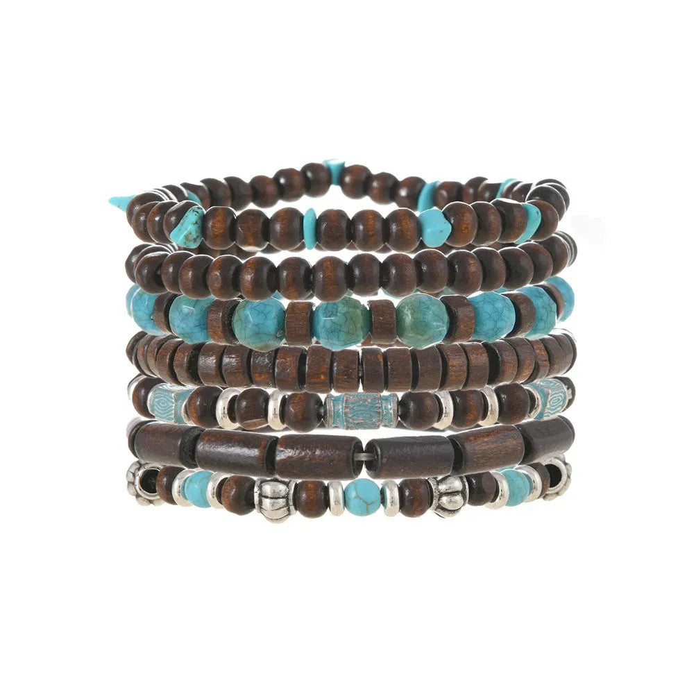 Seven multicoloured retro bracelets with wooden beads and alloy metal components arranged together
