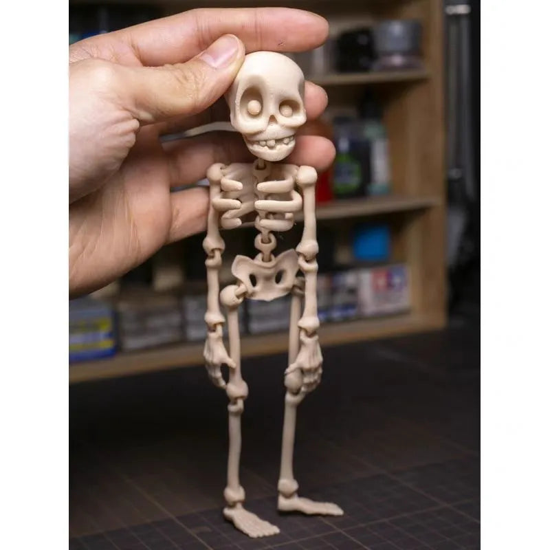3D-printed PLA skull model Halloween fridge magnet ornament in luminous green colour.