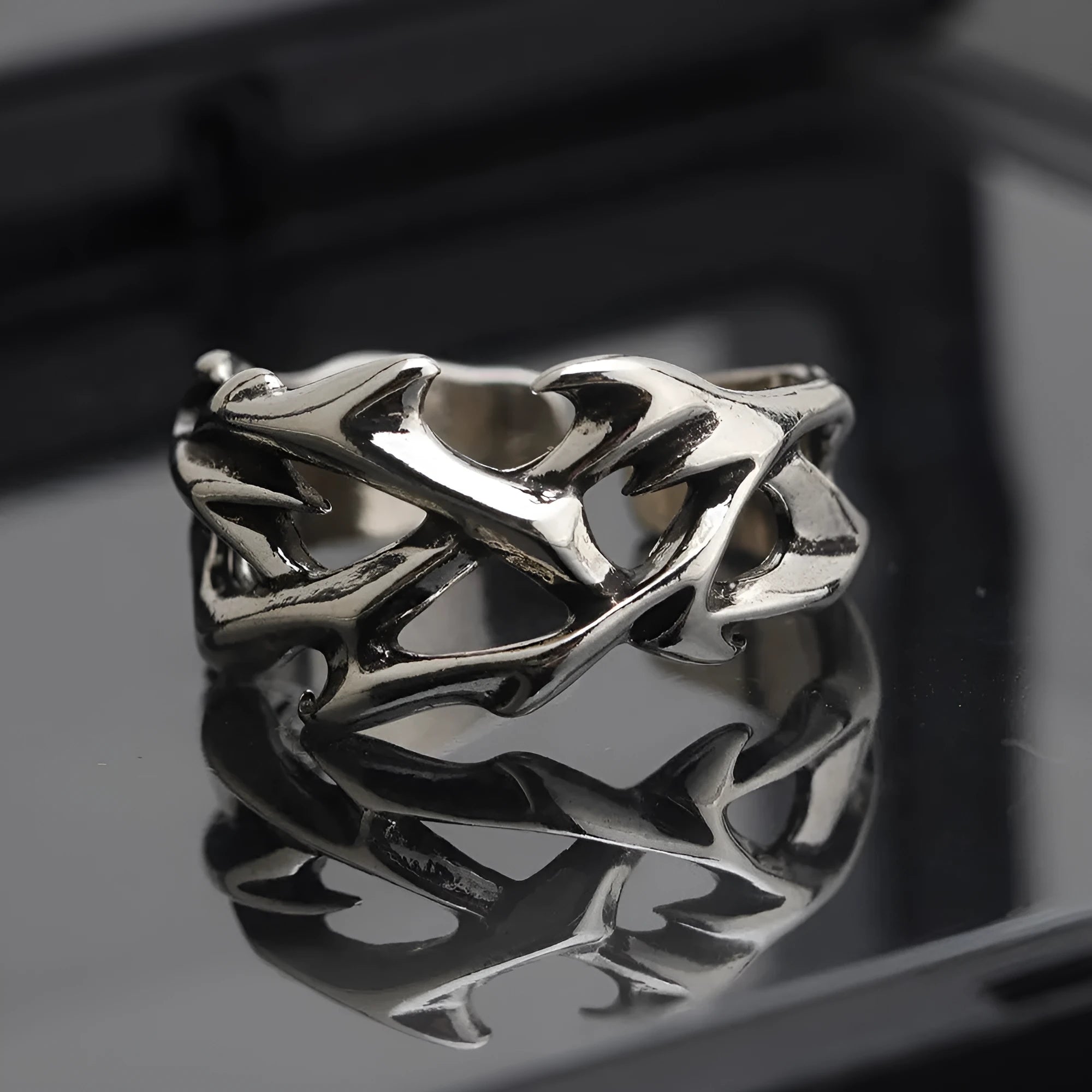 Copper men's ring with geometric thorn and flower design on an adjustable band.