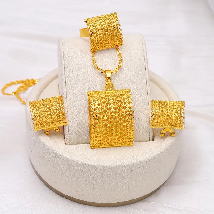 Gold coloured bridal jewellery set with necklace, earrings and ring on display