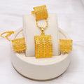 Gold coloured bridal jewellery set with necklace, earrings and ring on display