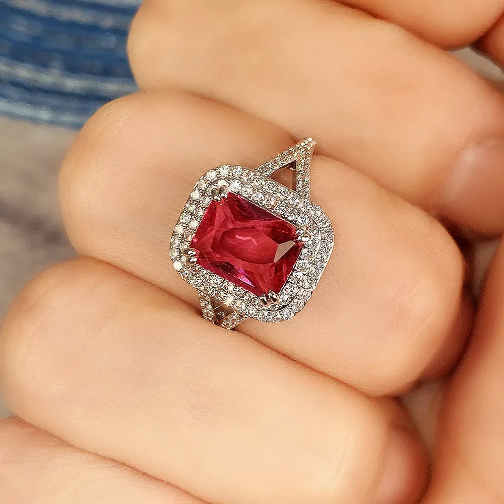 Copper geometric square ring with rhinestones in F827 red, shown on a finger.