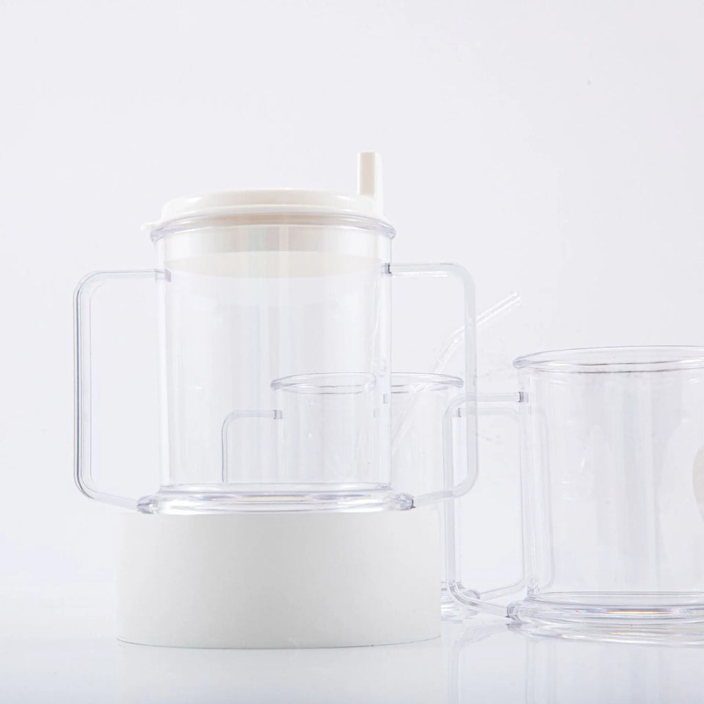 Transparent spill-proof drinking cup with straw lid showing modern minimalist design
