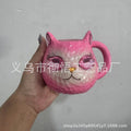Crystal Earth globe decorative ornament on top of a colourful cat-shaped resin cup.