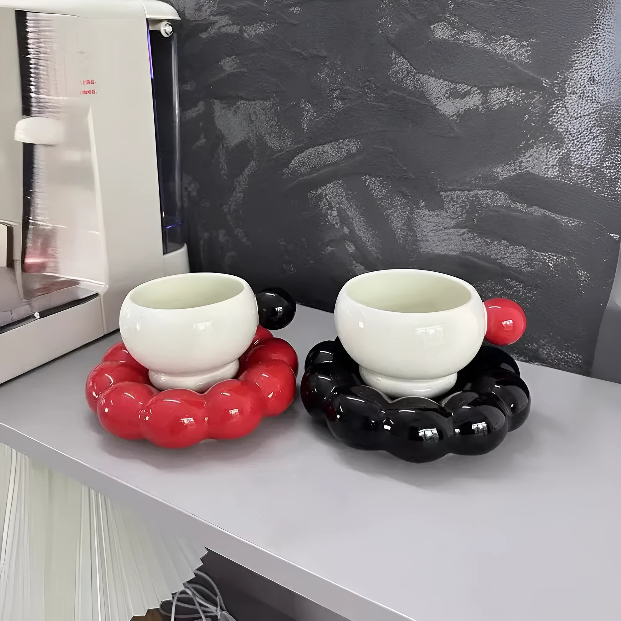 Ceramic coffee set with cup and dish in solid colour options including pea green, pink, brown, and red/black combinations