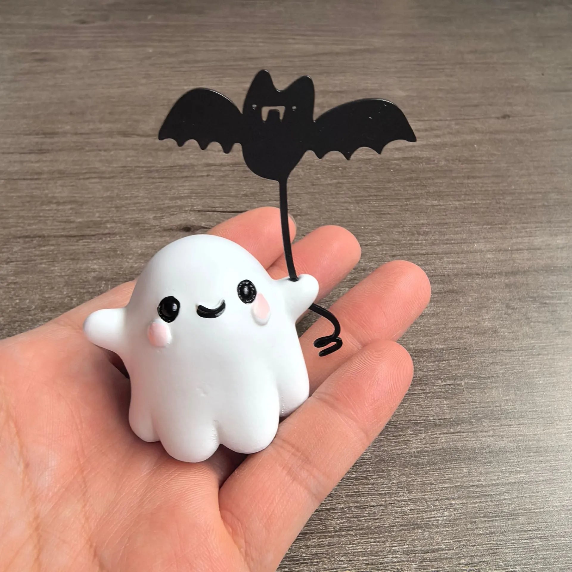 Mini resin statue of a ghost walking a dog and holding a bat, Halloween decoration.