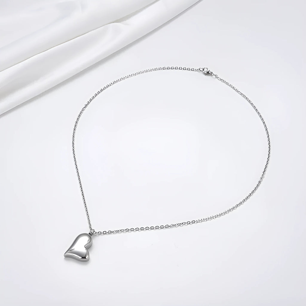 Silver curved peach heart pendant necklace on a chain with extension