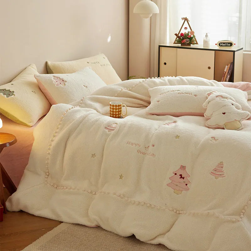 Winter milk fibre four-piece bedding set with printed green Christmas tree pattern on a bed.