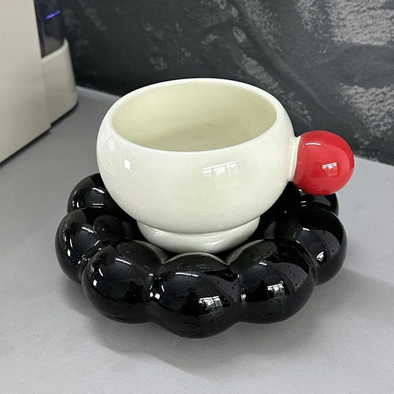 Ceramic coffee set with cup and dish in solid colour options including pea green, pink, brown, and red/black combinations