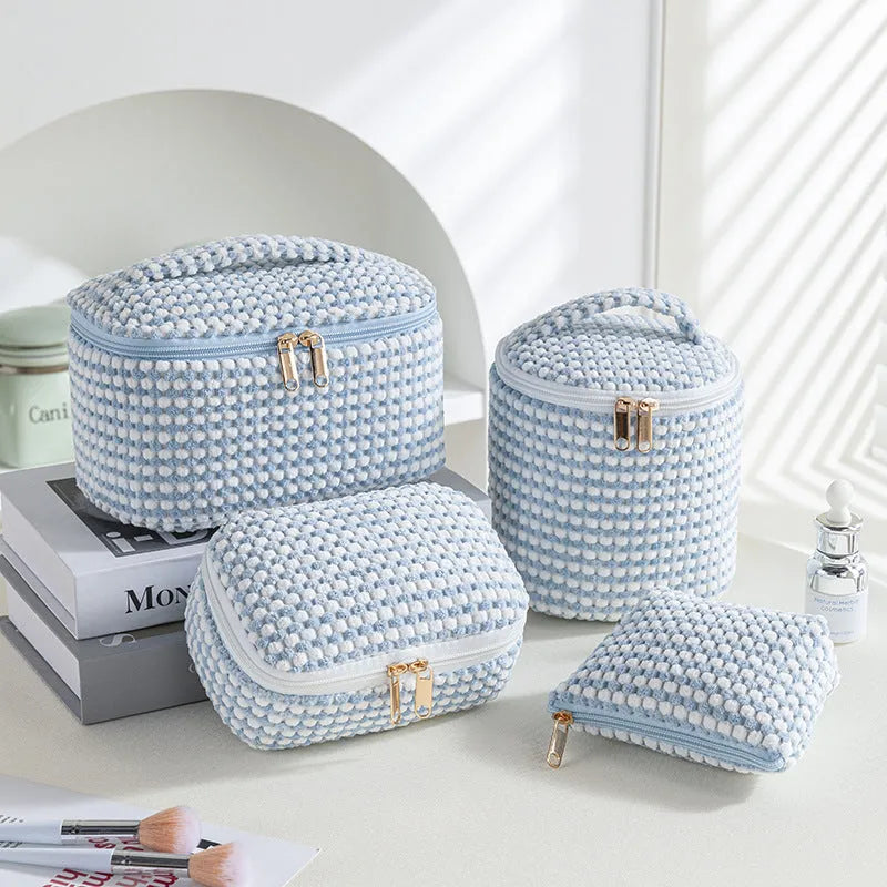 Set of four cube-shaped flannelette makeup bags in a choice of colours including pink dots and blue with dots.