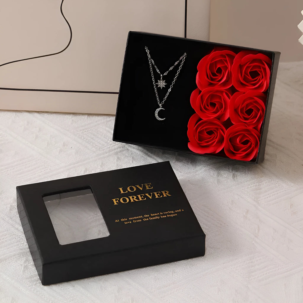 Six red soap flowers arranged in a black gift box with a matching handbag, a Valentine's Day gift set.